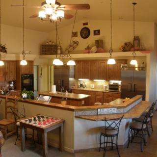 Modern kitchen with a dining area and bar seating.