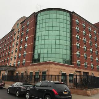 A modern brick hotel featuring a large glass facade.