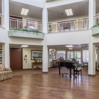 Spacious lobby area with a grand piano and seating arrangements.