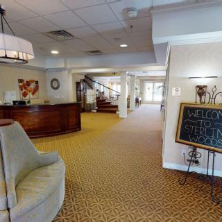 A welcoming hotel lobby featuring a reception desk, comfortable seating, and elegant lighting.