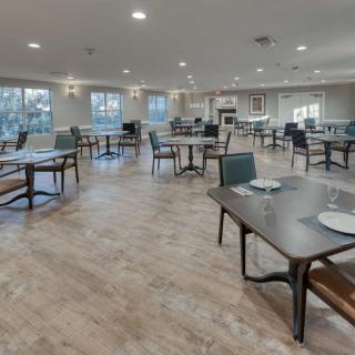 A modern and spacious dining area with neatly arranged tables and chairs.