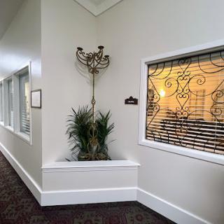 A well-lit hallway featuring decorative elements and a potted plant.