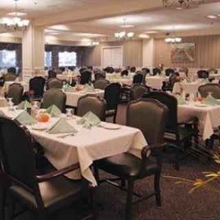 An elegantly set dining room with neatly arranged tables and chairs.
