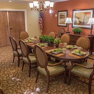 An elegantly decorated dining room with a set table and comfortable chairs.