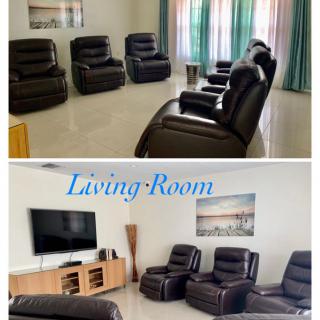 A cozy living room featuring leather recliners and a flat-screen TV.