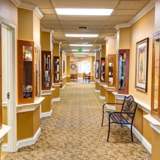 A well-lit hallway with decorative elements and seating.