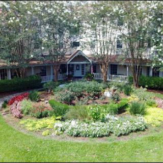 A beautifully landscaped garden surrounding a charming building.