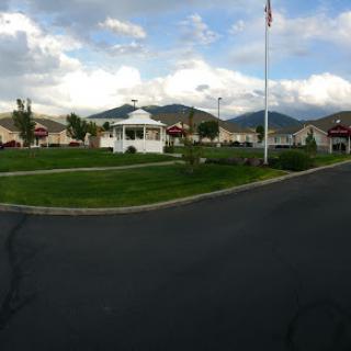 A picturesque neighborhood scene with a view of the mountains and a flag flying in the breeze.