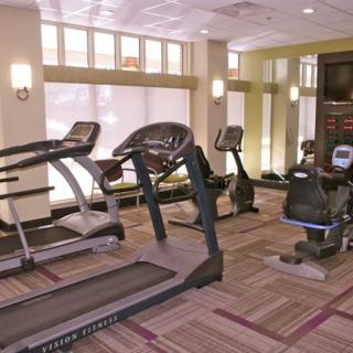 A modern fitness center featuring treadmills and stationary bikes.