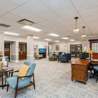 A spacious office lobby with comfortable seating and elegant furnishings.