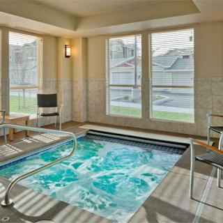 A serene indoor spa area featuring a hot tub, perfect for relaxation and rejuvenation.