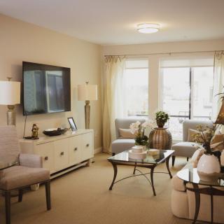 A cozy and elegantly decorated living room with neutral tones.
