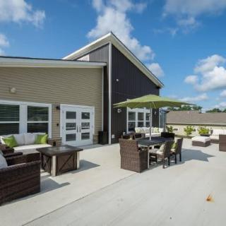 A modern outdoor patio with comfortable seating and a large umbrella.