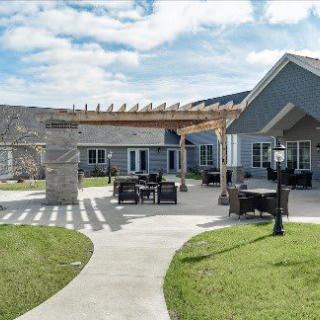 A modern house with a spacious outdoor patio and well-maintained lawn.