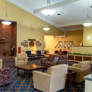 Spacious hotel lobby with comfortable seating and warm lighting.