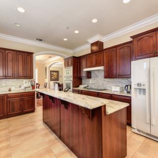 A modern kitchen with wooden cabinets and a central island.