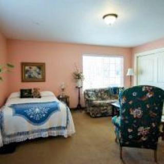 A cozy bedroom with traditional decor and floral furniture.