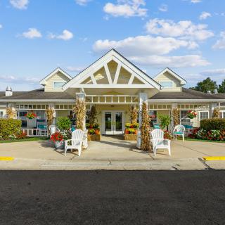 Front view of a building with a welcoming entrance decorated with seasonal items.