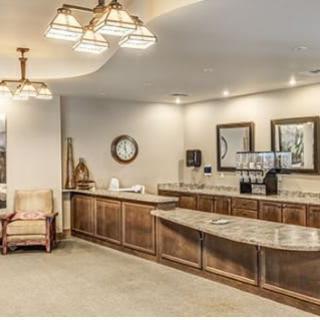 A cozy reception area with wooden furniture and warm lighting.