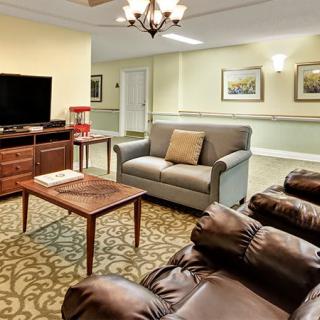 A cozy living room with comfortable seating, a television, and elegant decor.