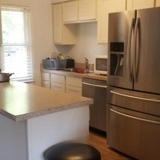 A modern kitchen with stainless steel appliances and a spacious countertop.