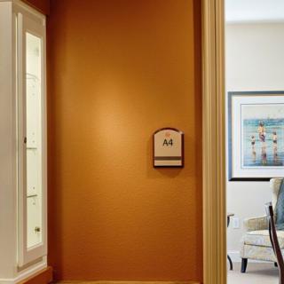 A cozy interior hallway with warm lighting and artwork on the wall.