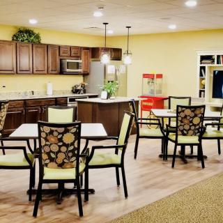 A cozy dining area with a kitchen setup and stylish seating.