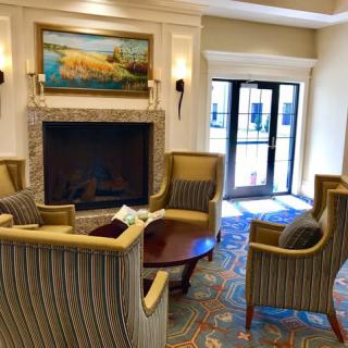 A cozy lounge area with a fireplace and comfortable seating.