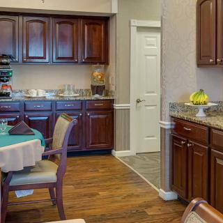 A cozy kitchen and dining area with wooden cabinets and a table set for dining.