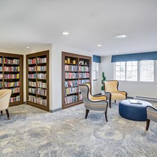 A cozy library reading area with bookshelves and comfortable seating.