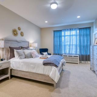 A well-decorated bedroom with modern furniture and a cozy atmosphere.