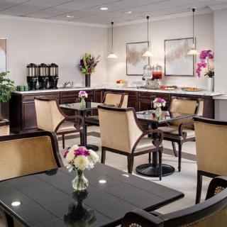 A cozy cafe interior with elegant seating and floral decorations.
