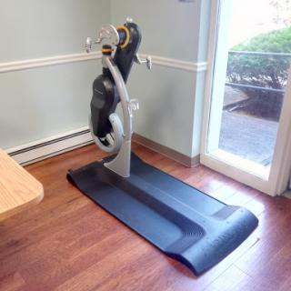 A treadmill positioned in a home gym setup.