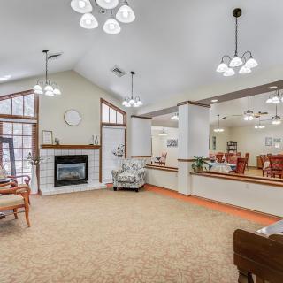 A spacious and cozy living room with elegant lighting and a fireplace.