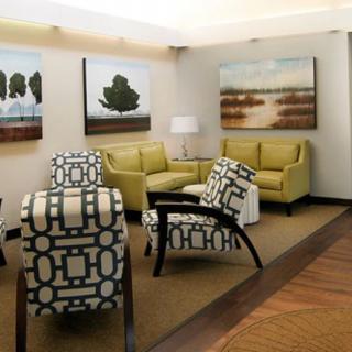 A modern lounge area with stylish furniture and contemporary artwork.
