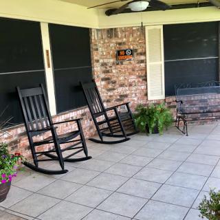 A cozy porch featuring rocking chairs and a serene atmosphere for relaxation.
