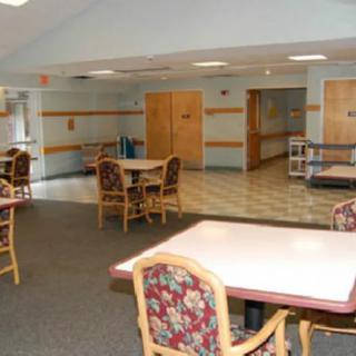 A spacious interior dining area with tables and chairs, designed for community gatherings.