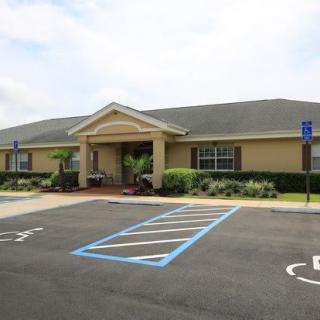 A single-story building with a parking lot featuring designated handicap spaces.