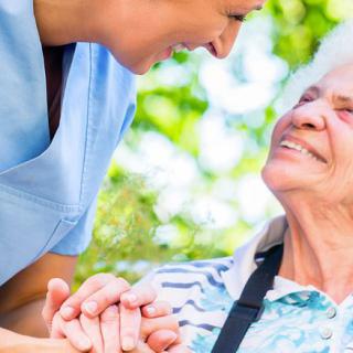 A nurse providing compassionate care to an elderly woman.