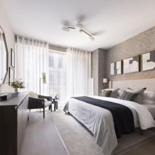 A modern and minimalist bedroom featuring neutral tones and stylish decor.