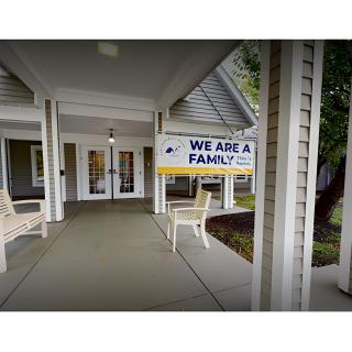 Entrance to a building with a sign reading 'We Are a Family'.