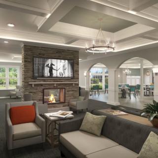 A modern living room with a cozy fireplace, stylish sofa, and elegant chandelier.