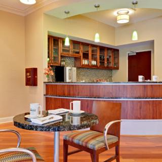 A contemporary lobby area featuring a reception desk and a cozy seating arrangement.