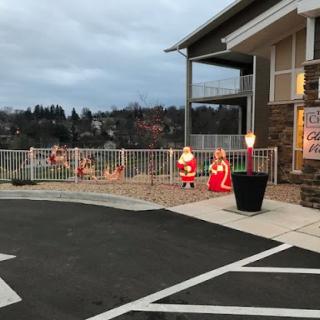 A festive outdoor display featuring Santa Claus decorations, welcoming the holiday season.