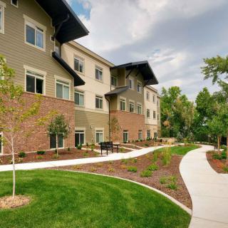 A well-maintained apartment building with a landscaped path and greenery.