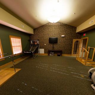 A cozy game room with a television and sports equipment.