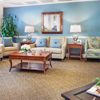 A cozy living room with sofas, a wooden coffee table, and decorative elements.