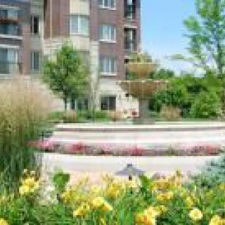 A well-landscaped garden in front of a residential building.