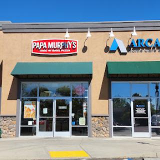 A storefront featuring Papa Murphy's pizza restaurant, known for its take-and-bake pizzas.
