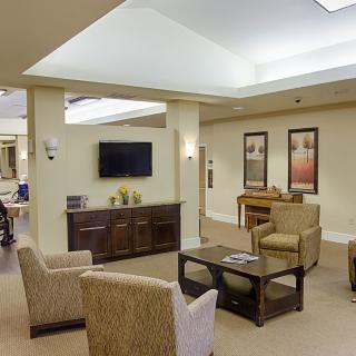 A cozy living room with comfortable seating, wall-mounted television, and tasteful decor.